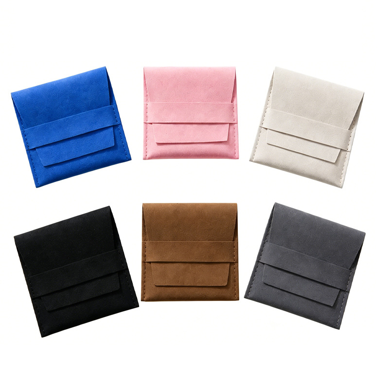 Blue, pink, cream, black, brown and gray accessory pouches with flap closures