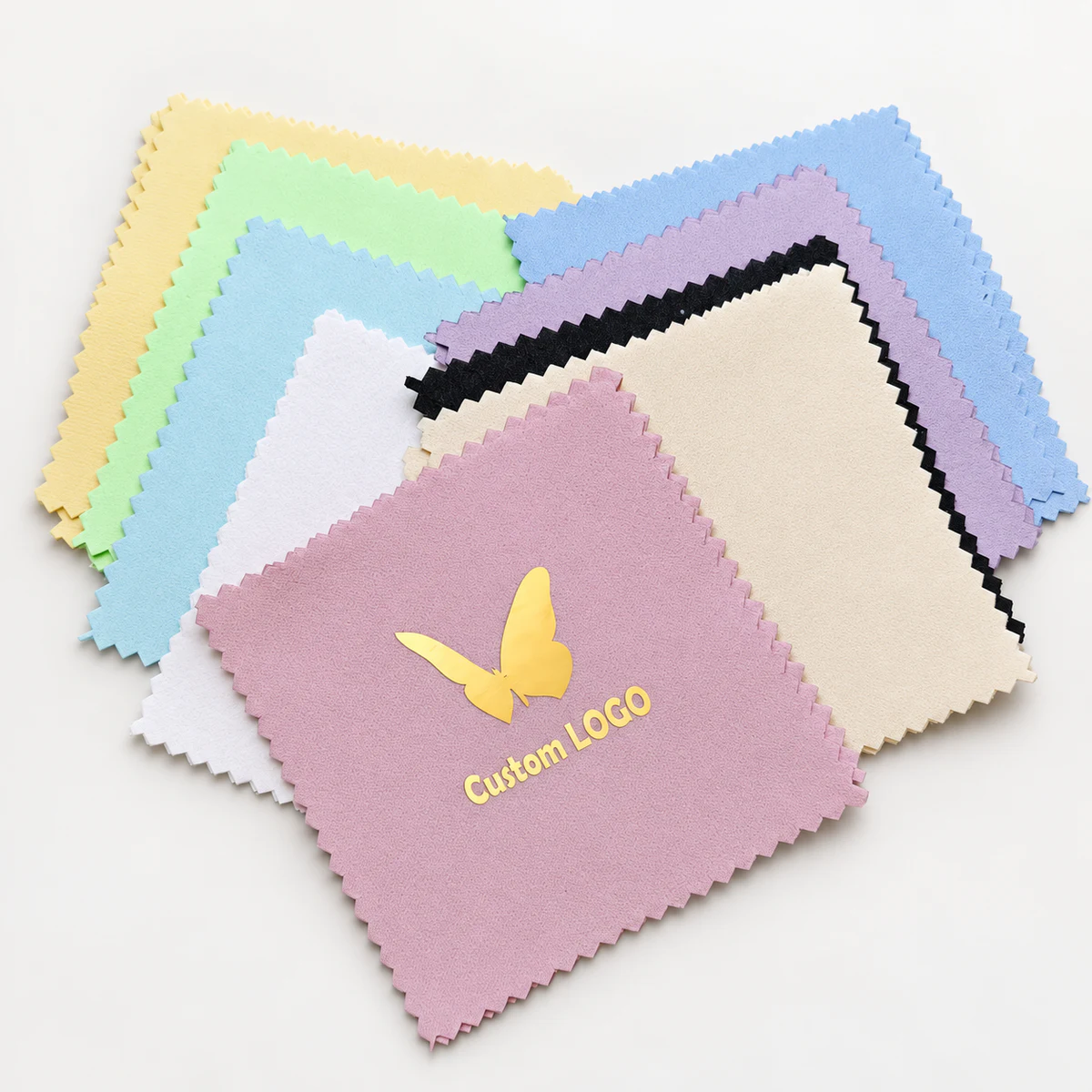 Assorted pastel silver polishing cloths with a gold butterfly and Custom LOGO print on the front pink cloth