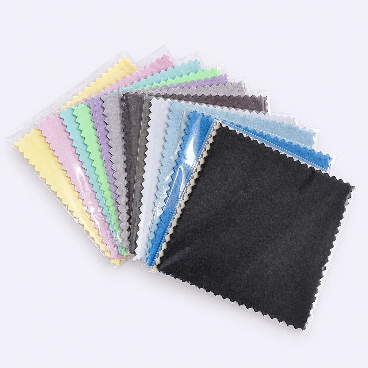 Black individually packaged silver polishing cloth with assorted colors behind
