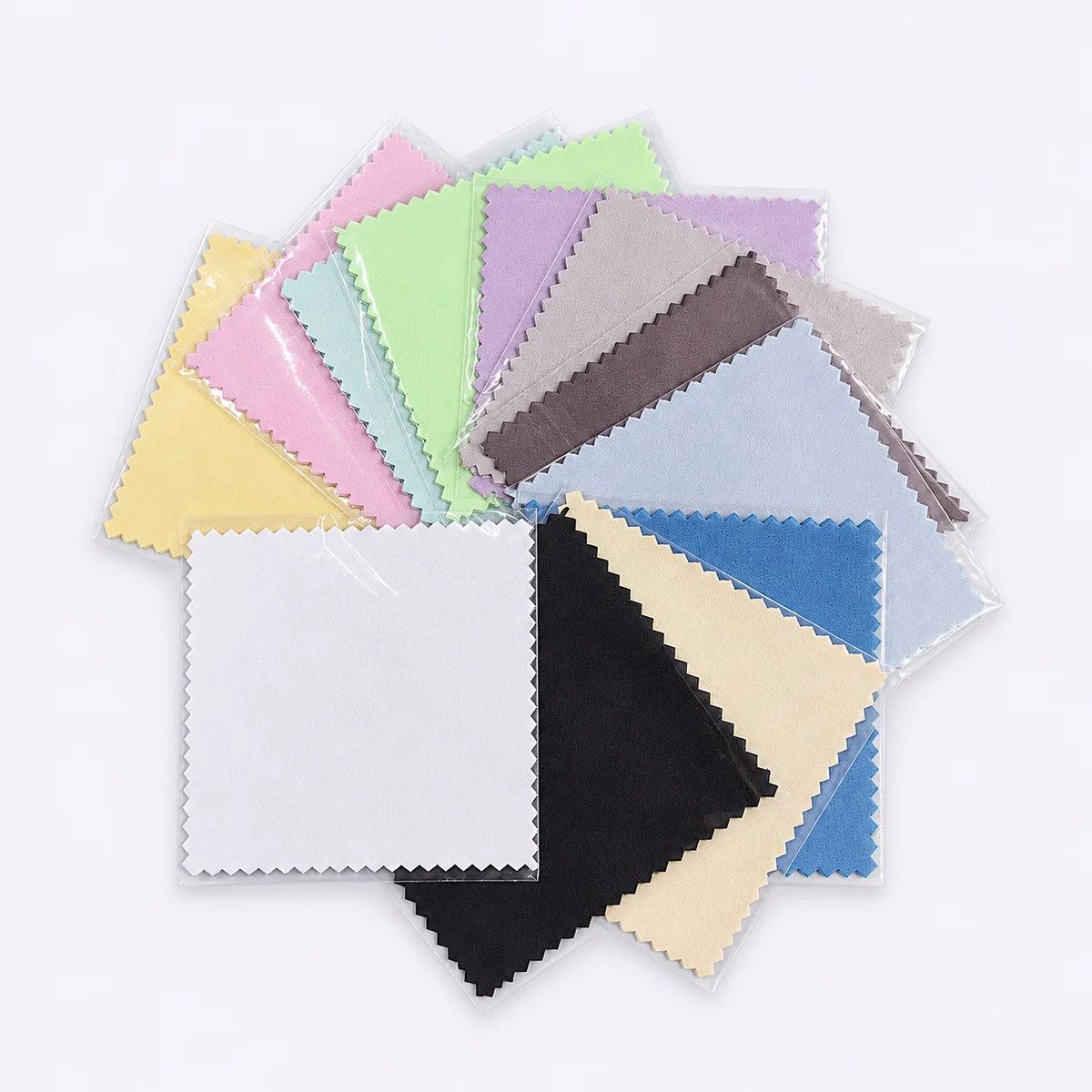 Assorted blue, mint, black and white silver polishing cloths in individual sleeves